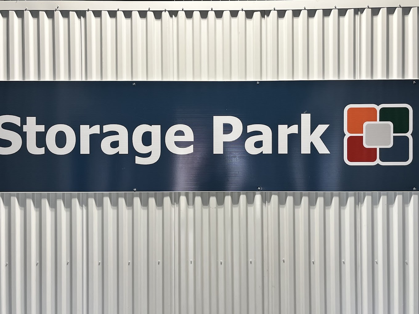Storage Park sign on a corrugated wall at the 2nd St facility