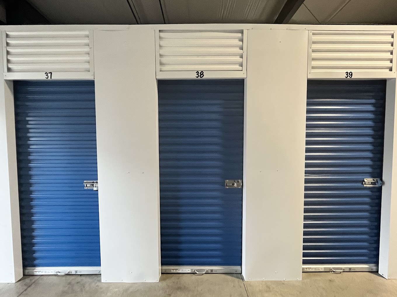 Indoor storage units 37, 38 and 39 with blue doors at Storage Park 2nd St