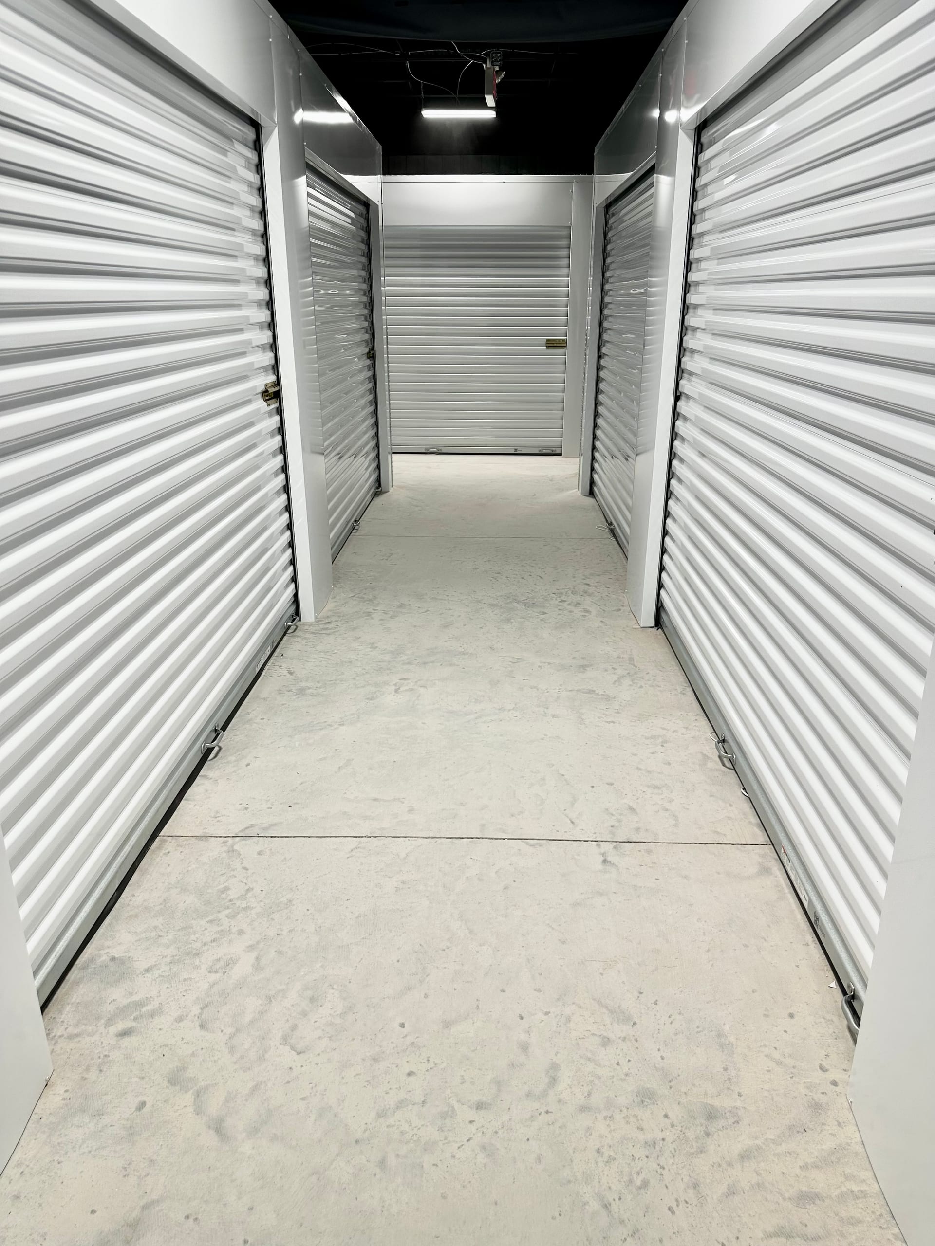 Indoor corridor lined with white storage unit doors at Storage Park Dayton